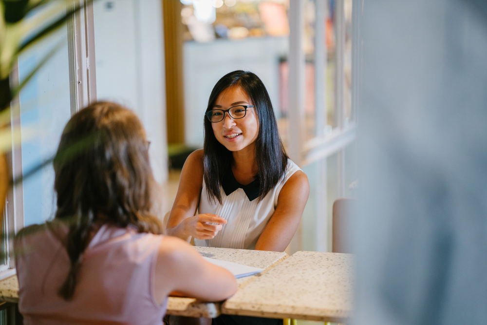 portrait,of,a,young,,asian,chinese,woman,in,a,meeting